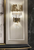 Opulent Gold And Clear Crystal Wall Lamp with Luxurious Tiered Design, Ideal for Sophisticated Ambient Lighting in Elegant Spaces